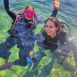 Load image into Gallery viewer, Two girls in scuba diving gear in clear water with pink masks
