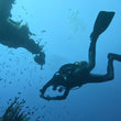 Load image into Gallery viewer, A diver's silhouette against the superstructure of the P29 shipwreck in Cirkewwa
