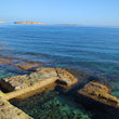 Load image into Gallery viewer, Sirens Reef with sea pools in St Pauls Bay showing a flat Mediterranean sea
