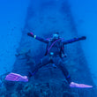 Load image into Gallery viewer, a diver posing above the p29 wreck in Malta after finishing skills on the PADI wreck diver course
