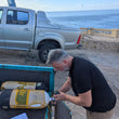 Load image into Gallery viewer, A diver using a nitrox analyser to check his gas before diving on the PADI enriched air diver course in Malta
