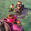 Load image into Gallery viewer, Two scuba divers in clear water, holding a regulator and practicing skills
