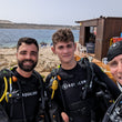 Load image into Gallery viewer, 3 divers in Scuba gear taking a selfie before diving at Qawra Point on their PADI Reactivate scuba refresher
