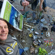 Load image into Gallery viewer, Trash organised and categorised outside New Dimension Scuba dive centre in Saint Paul's Bay after a debris dive, including plastic bottles, plastic spoons, cups, cloth, and a dive mask
