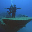 Load image into Gallery viewer, Two divers recreating the iconic Titanic pose on the bow of the Um El Faroud shipwreck
