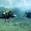 Load image into Gallery viewer, Two divers hovering during their safety stop after launching their DSMBs on the PADI DSMB specialty course
