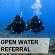 Load image into Gallery viewer, Two scuba divers hovering over the text "open water referral" on a reef dive in Malta

