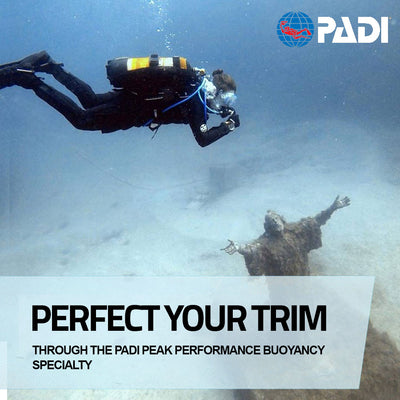A diver in trim above the statue of Jesus Christ after their PADI Peak Performance Buoyancy course in Malta
