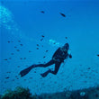 Load image into Gallery viewer, A diver in wing and long hose waves to the camera on a scuba dive in malta with clear blue water
